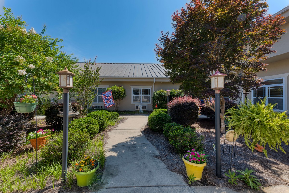 A charming house with a beautifully landscaped garden and pathway.