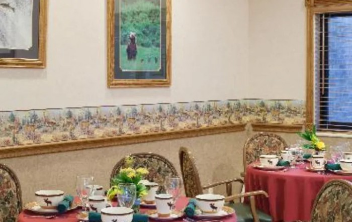 A well-decorated dining area with neatly set tables and wall artwork.