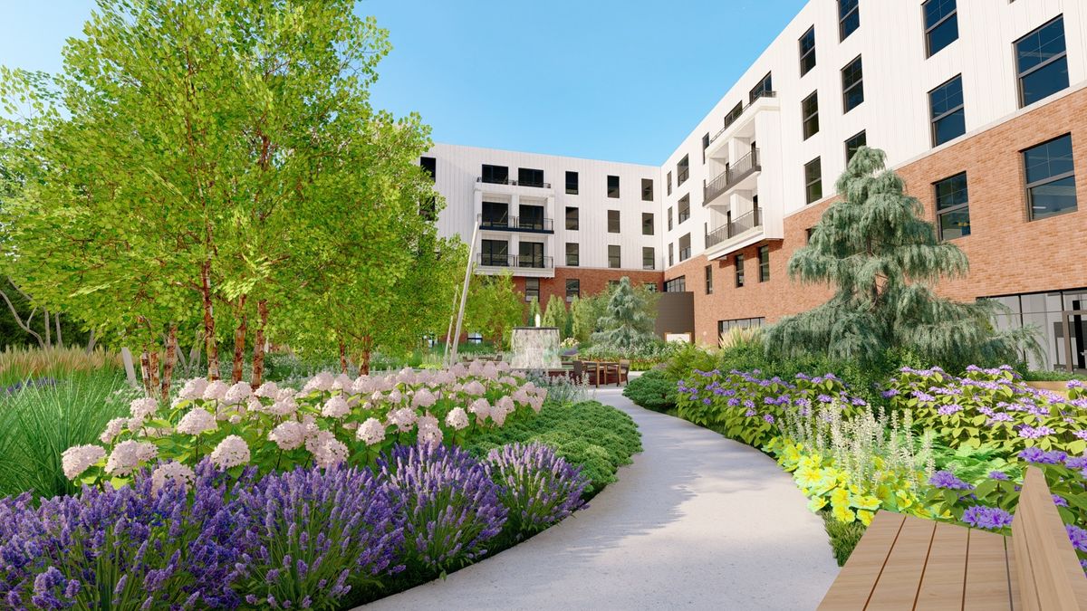 A beautifully landscaped garden with a winding pathway in an urban apartment complex.