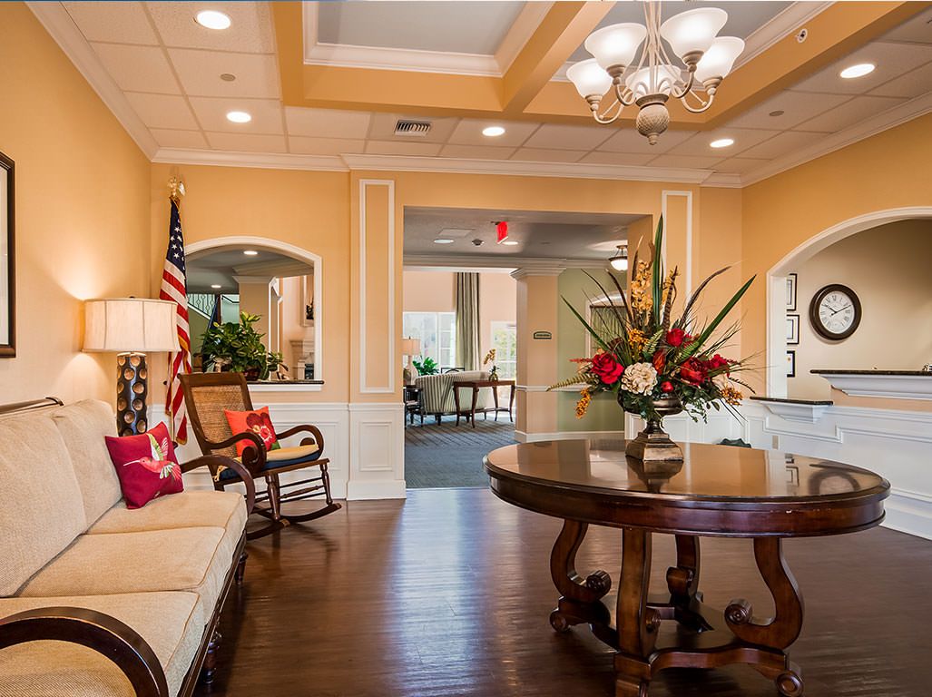 A well-decorated lobby with elegant furniture and floral arrangements.