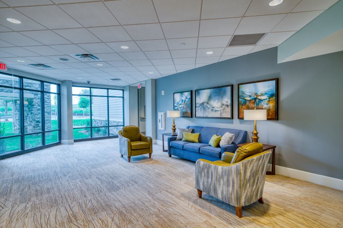 A modern lobby with comfortable seating and large windows.