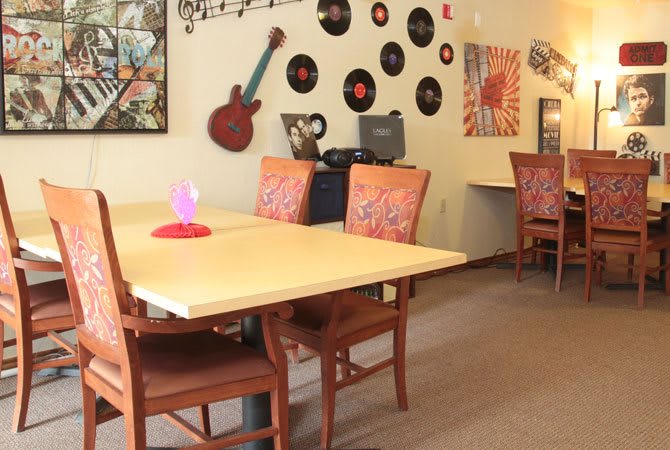 A cozy dining area decorated with vinyl records and a guitar on the wall.