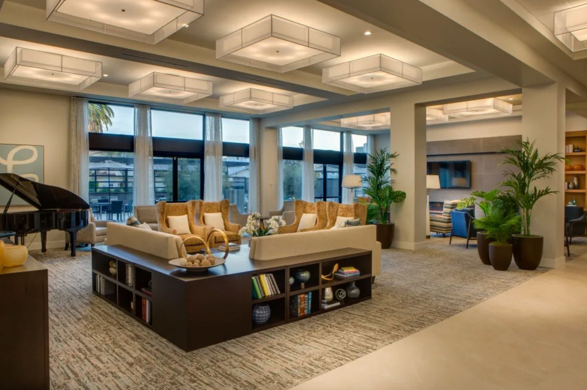 A spacious and modern lounge area with comfortable seating and large windows.