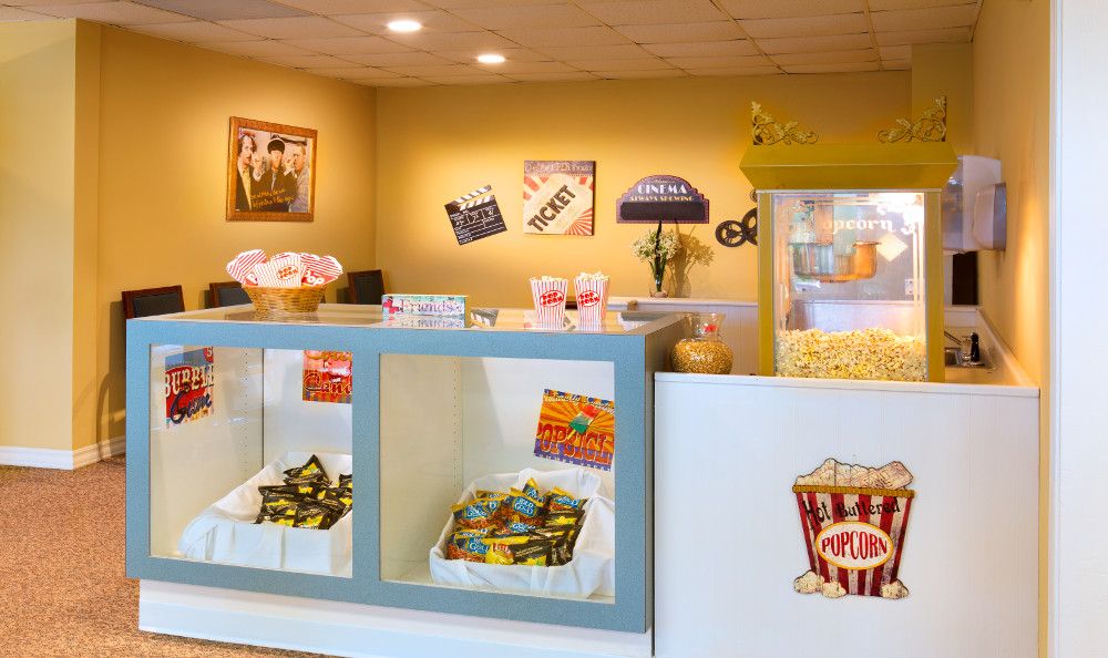 A concession stand in a movie theater with popcorn and candy on display.