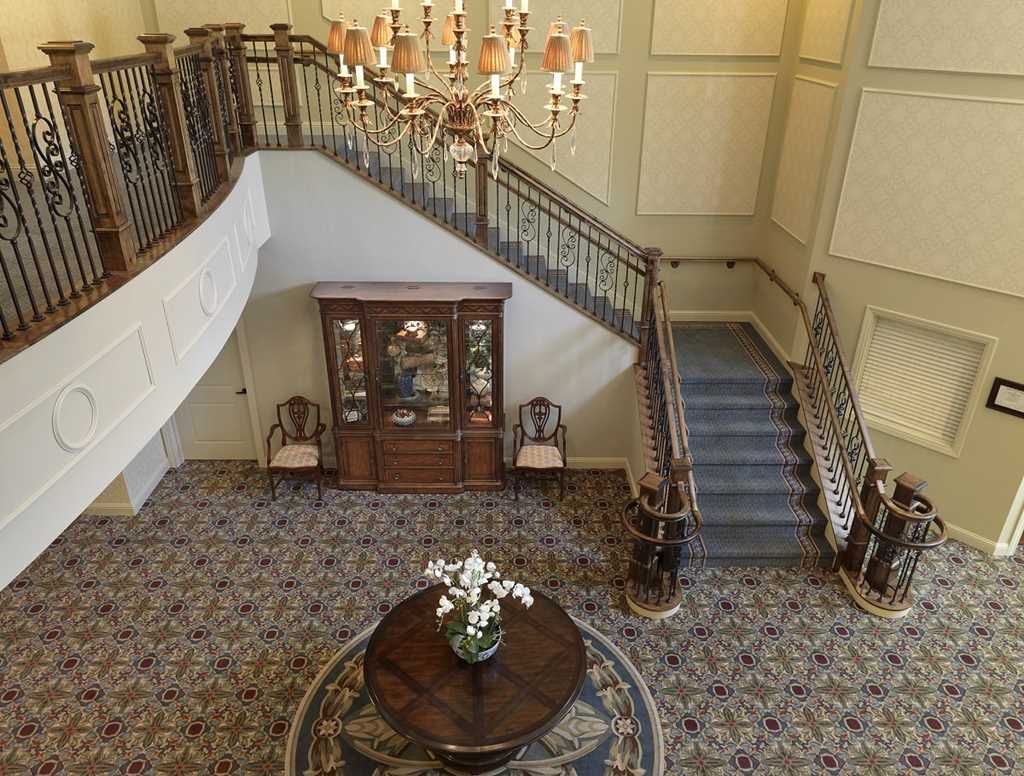 A luxurious interior featuring a grand staircase and a chandelier.