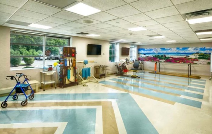 A spacious hospital lobby with modern design and medical equipment in view.