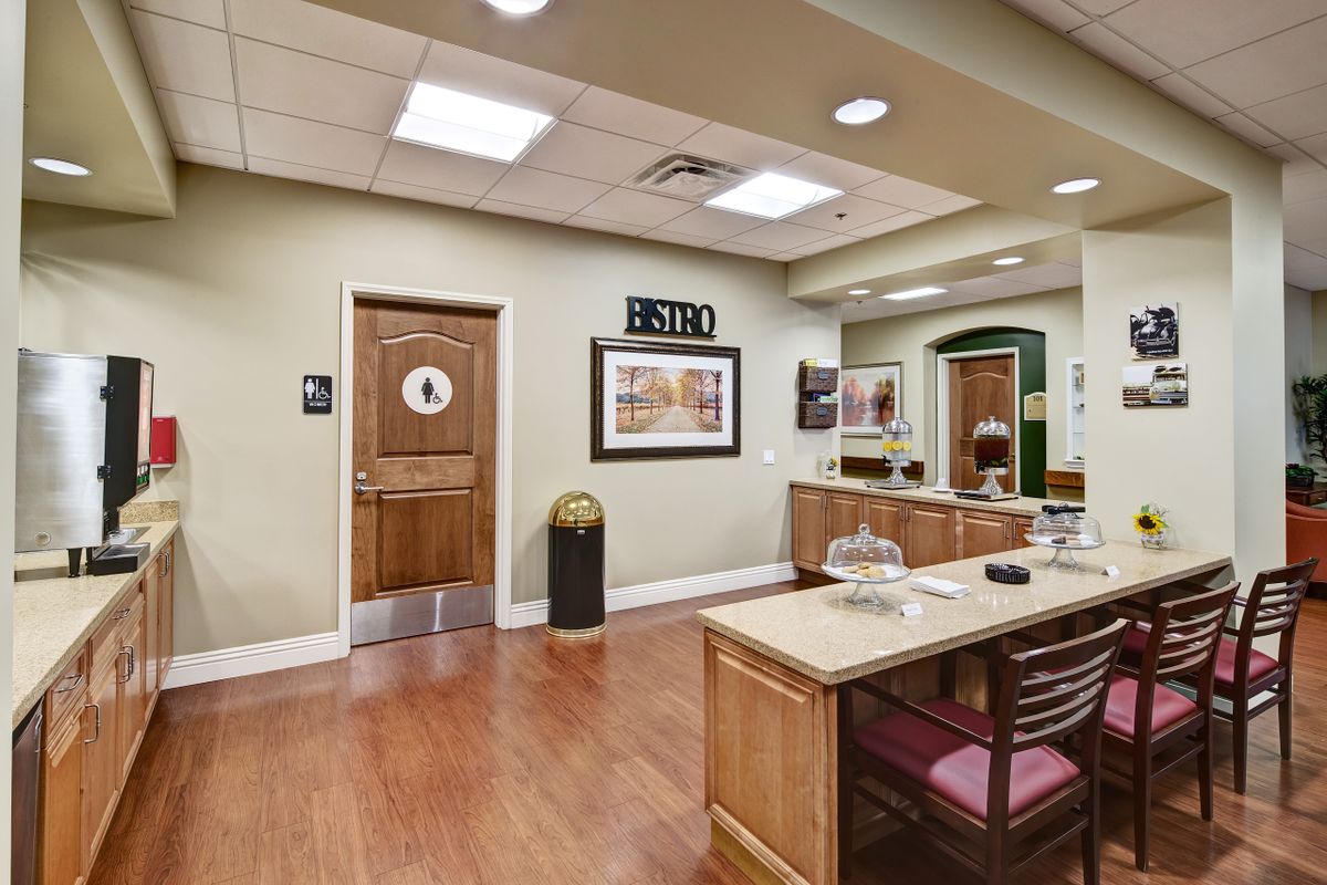 A welcoming reception area with a desk, waiting chairs, and decor on the walls.