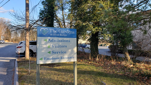 A sign displaying information for admissions, visitors, and services at a healthcare facility.