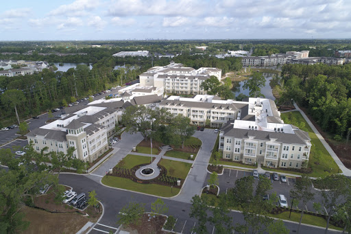 Aerial view of a modern residential complex surrounded by landscaped areas.