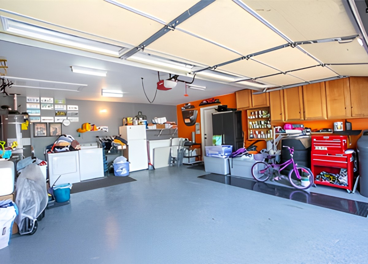 A well-organized garage with storage shelves, a bicycle, and various tools neatly arranged.