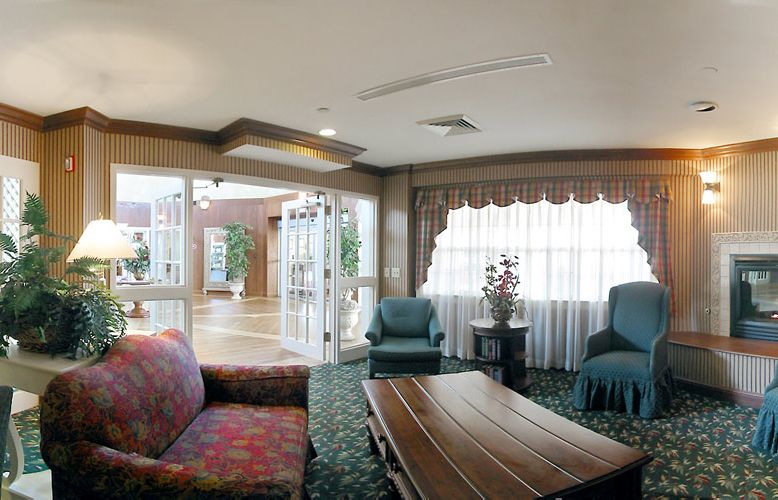 A cozy lobby area with comfortable seating and large windows.
