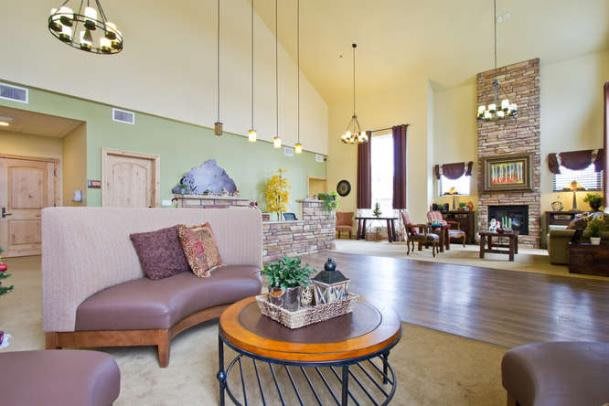 A spacious and cozy living room with comfortable seating, a stylish coffee table, and elegant lighting.