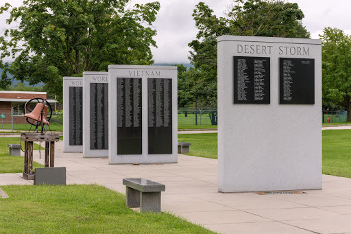 A memorial dedicated to honoring the deceased, featuring several plaques listing names.