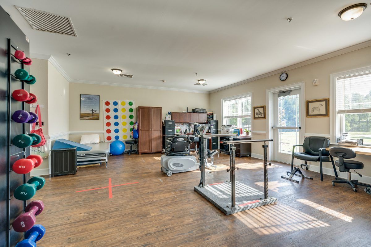 A well-equipped physical therapy room with various exercise machines and rehabilitation tools.