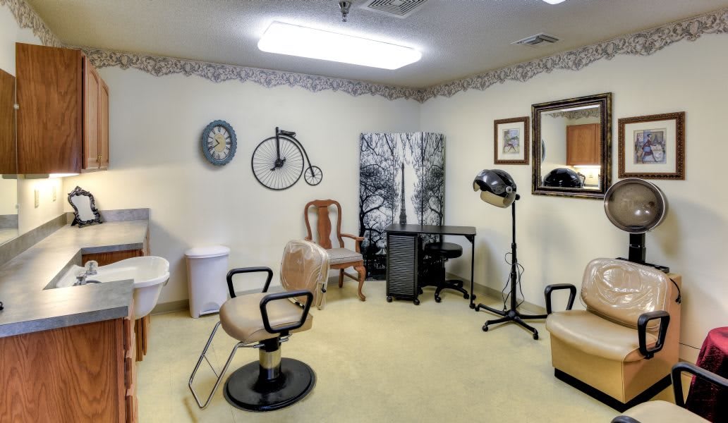 A quaint hair salon interior with chairs and vintage decor.