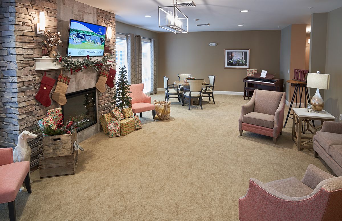 A cozy living room with a fireplace, TV, and comfortable seating.