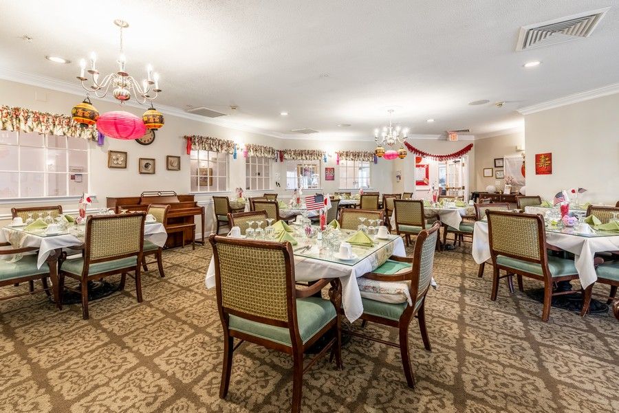 A tastefully decorated dining room with elegantly set tables and comfortable chairs.