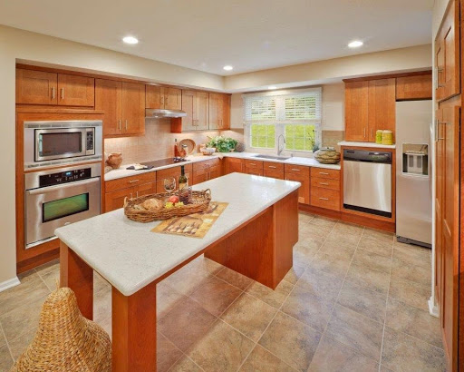 A modern kitchen featuring wooden cabinetry, sleek appliances, and a bright ambiance.