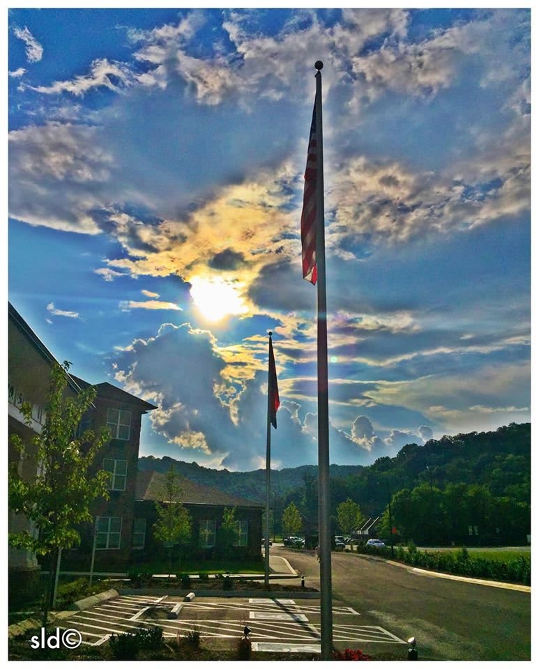 A scenic view of flags against a vibrant sunset sky.