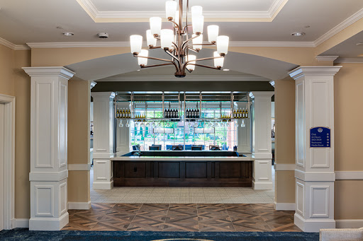 A stylish hotel lobby featuring a modern reception desk and elegant chandelier.