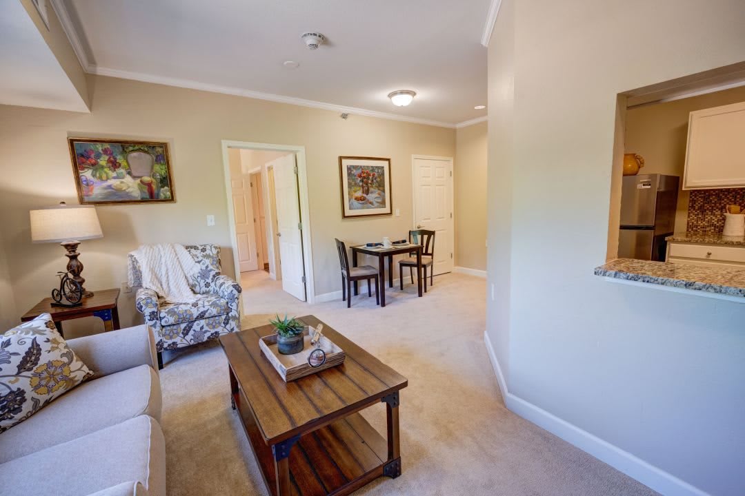A cozy living room with a small dining area, featuring comfortable furniture and stylish decor.