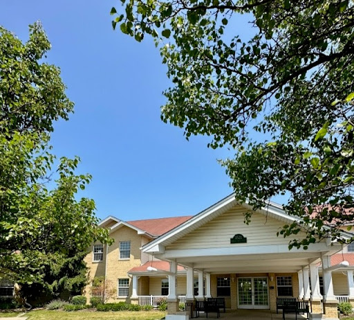 A sunny day showcasing a charming residential building framed by lush greenery.
