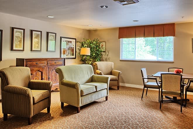 A cozy living room with comfortable seating, warm lighting, and tasteful decor.