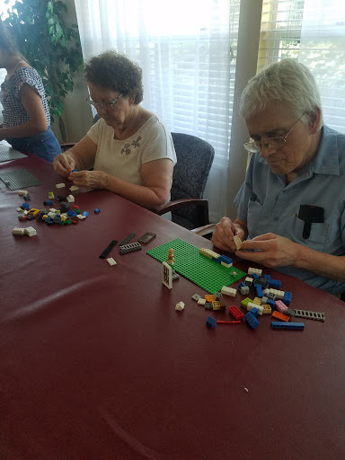 Seniors engaging in a creative LEGO building activity.