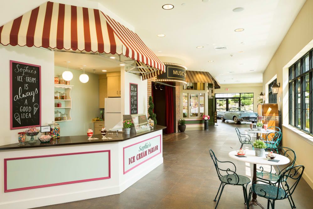 A charming ice cream parlor with a striped awning and cozy seating area.