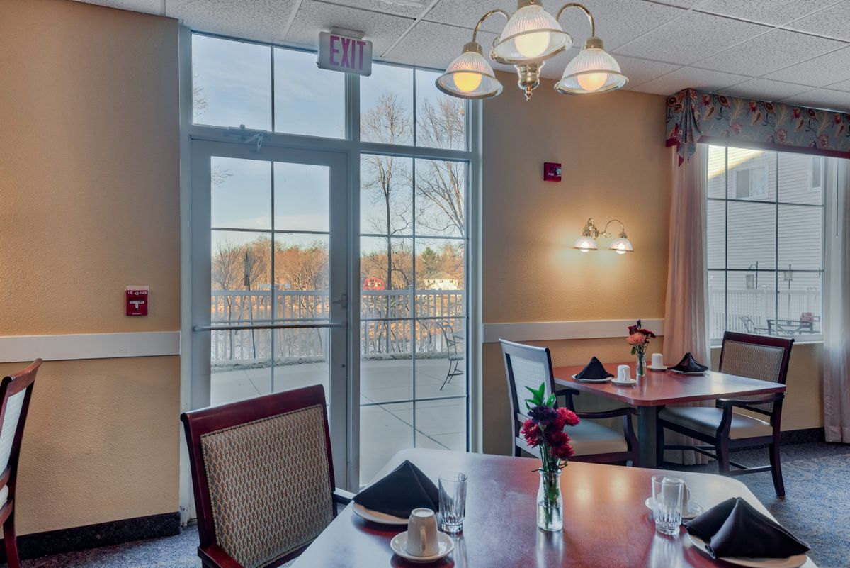 A cozy restaurant dining area with elegant lighting and a window view.
