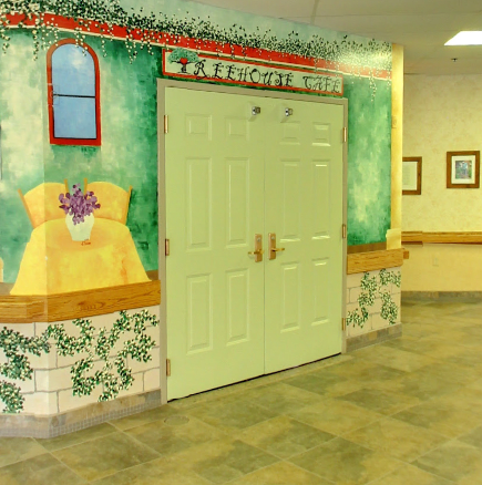 A hallway with a decorative mural in a healthcare facility.