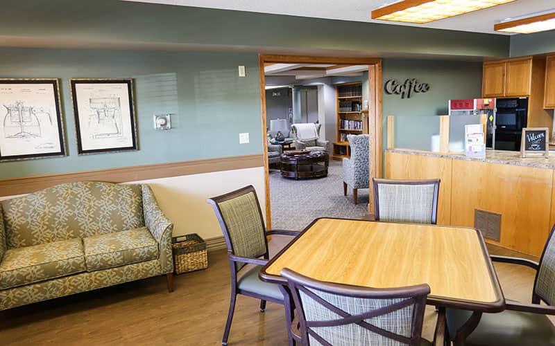 A comfortable lobby area with a table, chairs, and reception desk.