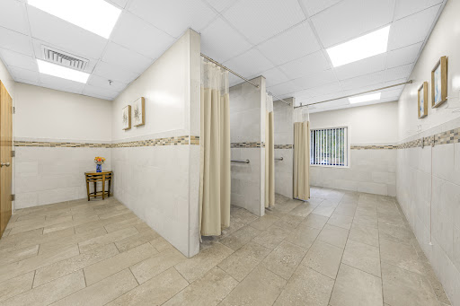 A clean and modern interior of a medical clinic featuring a waiting area and private consultation spaces.