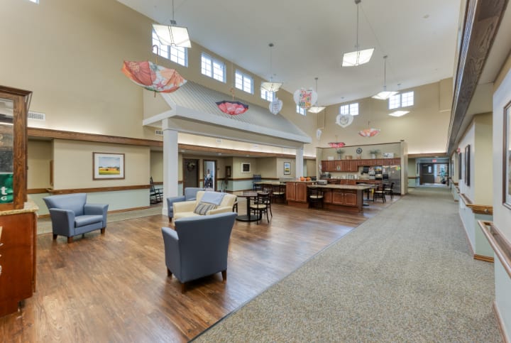 A spacious and modern common area with comfortable seating and unique lighting fixtures.