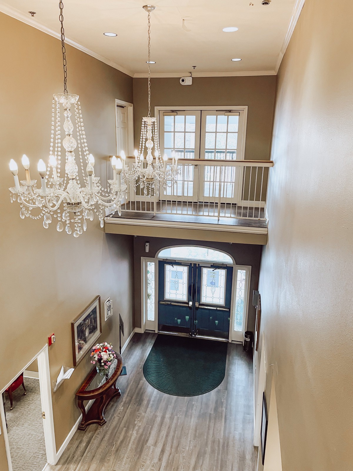 An elegant foyer featuring a grand chandelier and classic interior design.