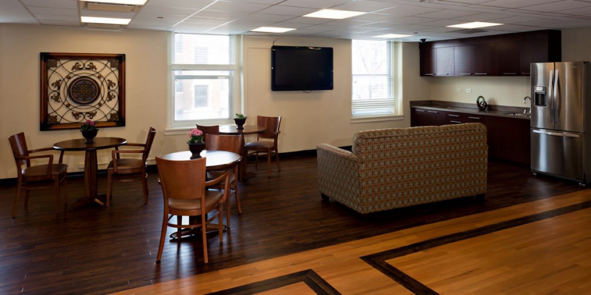 A cozy lounge area with comfortable seating, tables, and a mounted television.
