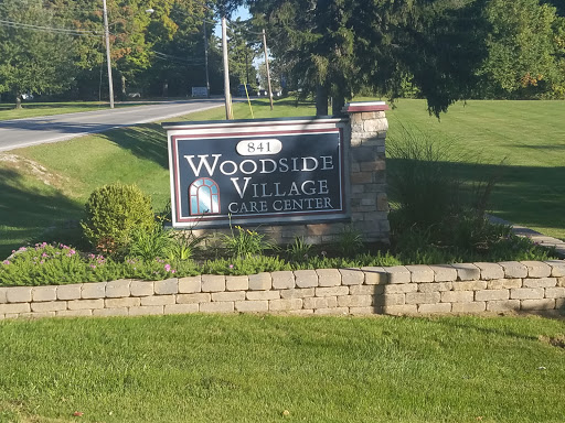 Entrance sign for Woodside Village, a residential community.