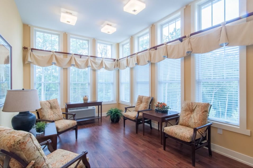 A bright, cozy living room with large windows and comfortable seating.