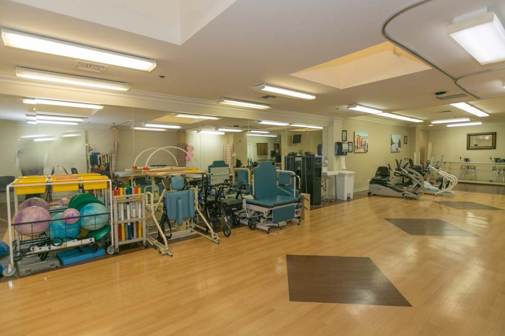 A well-equipped rehabilitation center featuring various exercise machines and tools used for physical therapy.