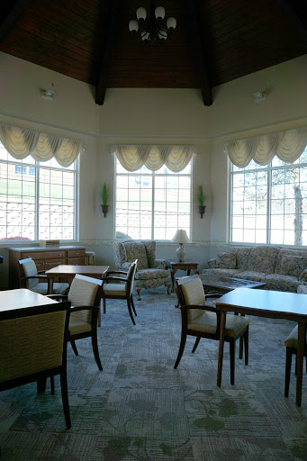A cozy lounge area featuring elegant furniture and large windows, inviting relaxation and social interaction.
