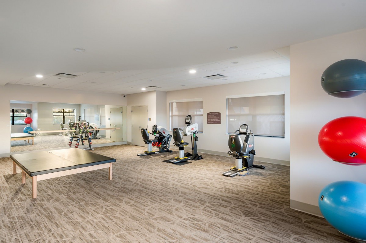 A modern fitness center featuring exercise equipment and training machines.
