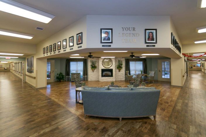 A cozy living room featuring a fireplace and comfortable seating, with photographs adorning the walls.