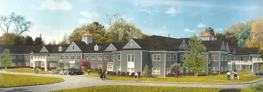 A modern residential building surrounded by greenery, with people walking in the foreground.