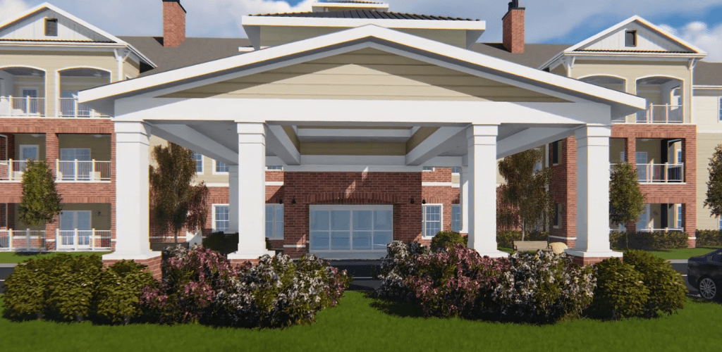 A building entrance featuring large columns and landscaped gardens.