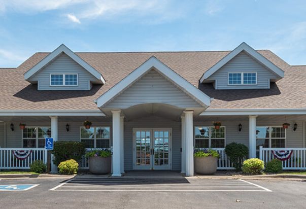 A suburban-style building with a symmetrical front entrance and columns.