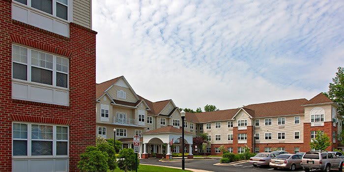 A suburban residential building under a cloudy sky.