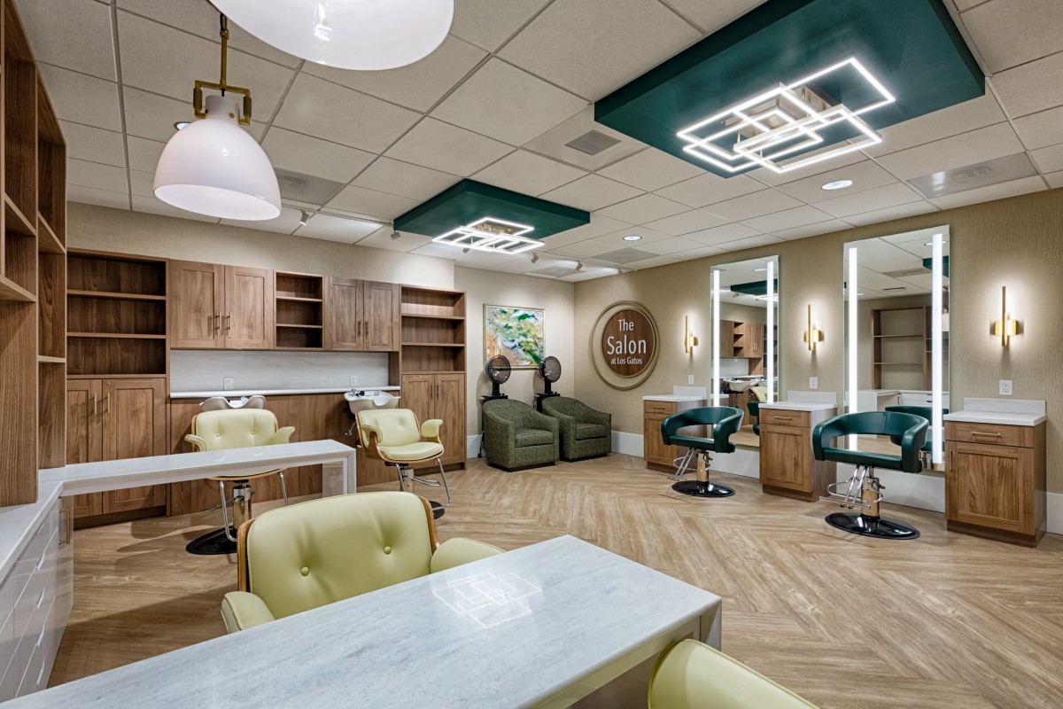A modern and stylish hair salon interior with comfortable seating and contemporary lighting.