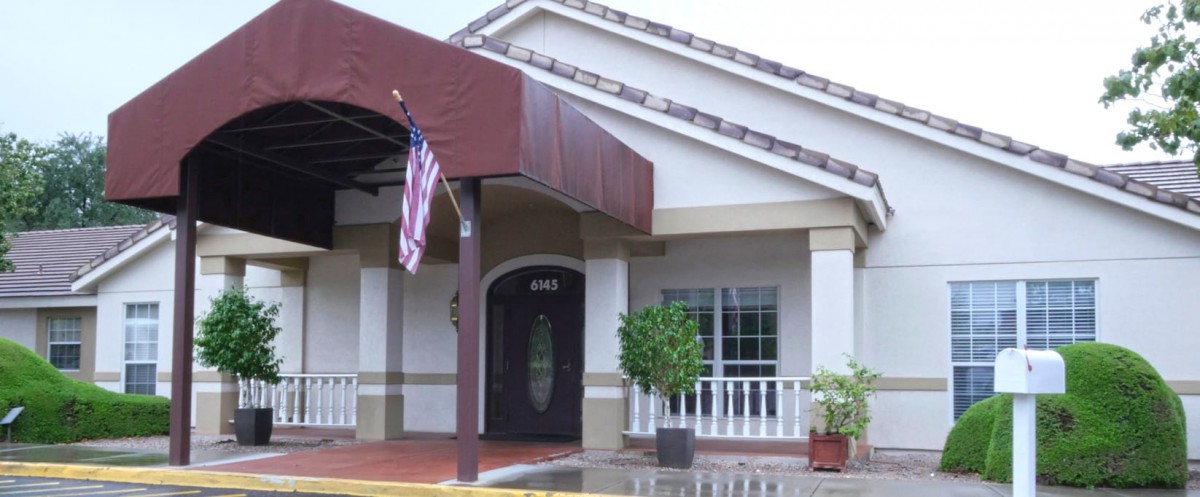 Entrance to a building with an American flag and awning.