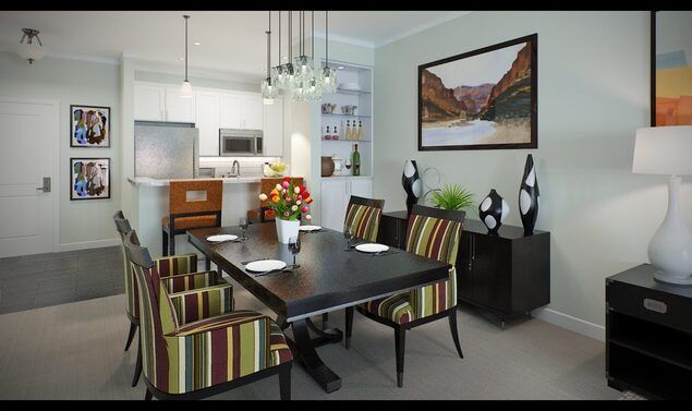 A modern dining room with striped chairs, a dark wooden table, and elegant pendant lighting.