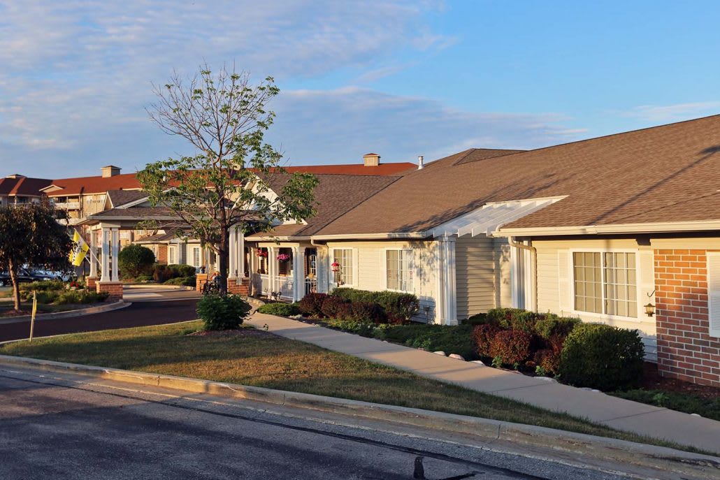 A row of suburban houses in a quiet residential neighborhood.